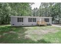 Inviting single-story home with gray siding, black shutters, new front deck, and spacious green lawn at 1380 St. Johns Church Rd, Concord, NC 28025