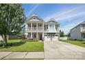 Inviting two-story home featuring a charming porch, a two car garage, and manicured lawn at 1437 Imperial Ct, York, SC 29745