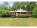 Charming brick house with covered entry, complemented by verdant landscaping and mature trees at 151 Deja Ln, Cleveland, NC 27013