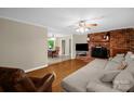 Spacious living room featuring hardwood floors, brick fireplace, and open dining area at 151 Deja Ln, Cleveland, NC 27013