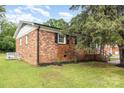 The backyard of this brick home is spacious, grassy and has nice landscaping at 16 Green St, York, SC 29745
