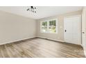Bright living room with sleek flooring, fresh paint, and natural light from a large window at 16 Green St, York, SC 29745
