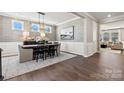 Formal dining room featuring wainscoting, elegant chandelier, and hardwood floors at 162 Nicholson Ln, Mooresville, NC 28115