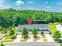 Aerial view of townhouses in a wooded area, showing driveways and landscaping at 2009 Talbert Ct, Charlotte, NC 28214