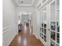 Charming foyer with hardwood flooring, arched entryways, and decorative wainscoting at 2178 Stone Pile Sw Dr, Concord, NC 28025