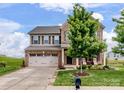 Charming two-story brick home with a well-manicured lawn, a two car garage, and a lovely front porch at 2178 Stone Pile Sw Dr, Concord, NC 28025