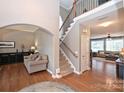 Spacious foyer with hardwood floors, staircase, and access to living areas at 2300 Lord Anson Dr, Waxhaw, NC 28173