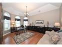 Bright home office featuring hardwood floors, natural light, and a modern chandelier at 2300 Lord Anson Dr, Waxhaw, NC 28173