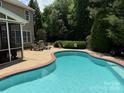 Inviting backyard pool with spacious patio area, perfect for outdoor entertaining and relaxation at 2300 Lord Anson Dr, Waxhaw, NC 28173