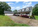Traditional home boasts a covered front porch, dormer windows and stone driveway at 2451 Reepsville Rd, Lincolnton, NC 28092
