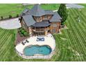 Stunning aerial view of backyard featuring a large in-ground pool and manicured lawn at 270 Sandhills Ct, Mooresville, NC 28115