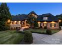 Inviting home at twilight showcasing warm exterior lighting and manicured landscaping at 270 Sandhills Ct, Mooresville, NC 28115