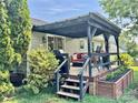 Enjoy outdoor living on this covered deck, perfect for relaxing or entertaining guests at 2810 Elizabeth Ave, Shelby, NC 28150