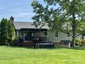 Large backyard featuring a covered back deck, mature trees, and plenty of green space at 2810 Elizabeth Ave, Shelby, NC 28150
