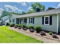 Single-story home featuring horizontal siding, complemented by well-maintained landscaping and a sidewalk at 2810 Elizabeth Ave, Shelby, NC 28150