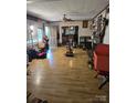 Large living room featuring multiple windows, ceiling fans, and hard surface flooring at 29386 Nelson Mountain Rd, Albemarle, NC 28001