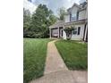 Traditional home with charming curb appeal, featuring a well-manicured lawn and inviting walkway at 327 Wilkes Place Dr, Fort Mill, SC 29715