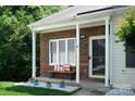 Cozy covered porch area with a bench, perfect for relaxing outdoors at 327 Wilkes Place Dr, Fort Mill, SC 29715