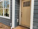 Close-up of a front door and a side window of a house with gray siding at 4049 Port Richmond Ave # 10, Gastonia, NC 28056
