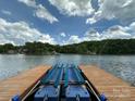 Dock boat lift ready for a boat, overlooking the tranquil lake and scenic surroundings at 408 Emerald Bay Dr, Salisbury, NC 28146