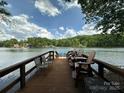 Spacious wooden dock with seating, ideal for enjoying lake views and water activities at 408 Emerald Bay Dr, Salisbury, NC 28146