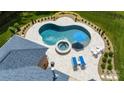Aerial view showcases the in-ground pool and travertine patio with lounge chairs and a hot tub at 408 Emerald Bay Dr, Salisbury, NC 28146