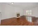 Spacious living room features a fireplace and wood floors at 4368 Yoruk Forest Ln, Charlotte, NC 28211