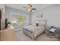 Cozy bedroom with a large window, neutral color palette, and comfortable furnishings, creating a relaxing atmosphere at 4532 Stellata Loop, Sherrills Ford, NC 28673