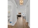 Bright hallway with wood floors leading to an open-concept living space and a modern kitchen at 4532 Stellata Loop, Sherrills Ford, NC 28673