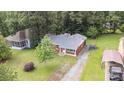 An aerial view of a brick ranch home with mature trees and a long driveway at 4915 Galax Dr, Charlotte, NC 28213