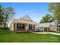 Beautifully designed home with a classic front porch and manicured lawn at 507 E Cloninger St, Dallas, NC 28034