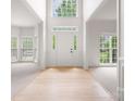 Bright foyer with hardwood flooring, soaring ceilings, and transom windows at 6504 Sybil Ct, Indian Trail, NC 28079