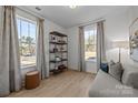 Cozy living room featuring large windows, modern shelving, and comfortable seating at 7130 Westrow Ave # 37 End, Charlotte, NC 27278