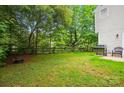 Spacious backyard with a grill, fire pit, seating, and mature trees, perfect for outdoor entertaining at 8014 Sherington Way, Charlotte, NC 28227