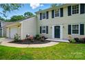 Well-maintained two-story home featuring a landscaped front yard and attached garage at 8014 Sherington Way, Charlotte, NC 28227