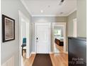 Inviting entryway with hardwood floors, white trim, and views into the dining room and bedroom at 930 Jetton St, Davidson, NC 28036