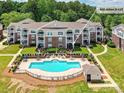 Beautiful condo building with a pool and outdoor seating in a well-maintained community, located at 930 Jetton St #25 at 930 Jetton St, Davidson, NC 28036