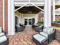 Cozy outdoor patio with comfortable seating, brick flooring and ceiling fan overlooking the serene outdoors at 930 Jetton St, Davidson, NC 28036