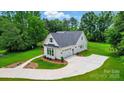 Beautiful home with an attached garage, a spacious driveway, and manicured landscaping at 9311 Simpson Rd, Waxhaw, NC 28173