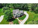 Expansive aerial view of the property featuring lush landscaping and a long driveway at 9315 Simpson Rd, Waxhaw, NC 28173