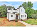 Beautiful new construction farmhouse with modern curb appeal, board and batten siding, and manicured front yard at 1011 Sandy Ct, Gastonia, NC 28056