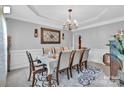 Elegant dining room featuring a chandelier, decorative rug, and seating for eight at 10515 Greenhead View Rd, Charlotte, NC 28262