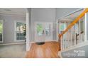 Inviting foyer with hardwood floors, staircase, and natural light streaming through the front door at 10515 Greenhead View Rd, Charlotte, NC 28262