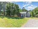Inviting single-story home with large front lawn, mature trees and neutral gray color at 1103 Oklahoma St, Kannapolis, NC 28083