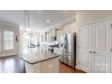 Bright kitchen featuring stainless steel appliances, granite countertops, and a spacious island at 123 Hanks Bluff Dr, Mooresville, NC 28117