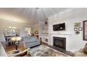 Elegant living room featuring a fireplace, built-in shelving, and hardwood flooring at 123 Hanks Bluff Dr, Mooresville, NC 28117
