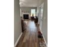 Inviting view of the living room and fireplace from the hallway in neutral tones at 1421 Piney Church Rd, Concord, NC 28025