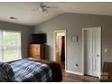 Relaxing main bedroom featuring a bed, dresser, and window, with the en-suite bathroom visible at 1421 Piney Church Rd, Concord, NC 28025