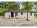 Ranch home with gravel yard, newly refinished siding, black trim, and inviting front entrance at 1574 Mangum Dr, Lancaster, SC 29720