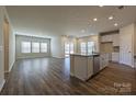 Bright, open-concept kitchen and living area features a large island and plenty of natural light at 1600 Baymont Ct, Stanley, NC 28164
